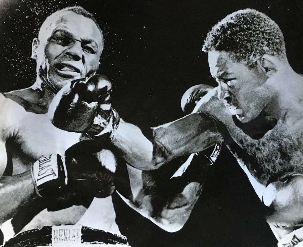 Ezzard Charles on the right delivering a blow to challenger Jersey Joe Walcott