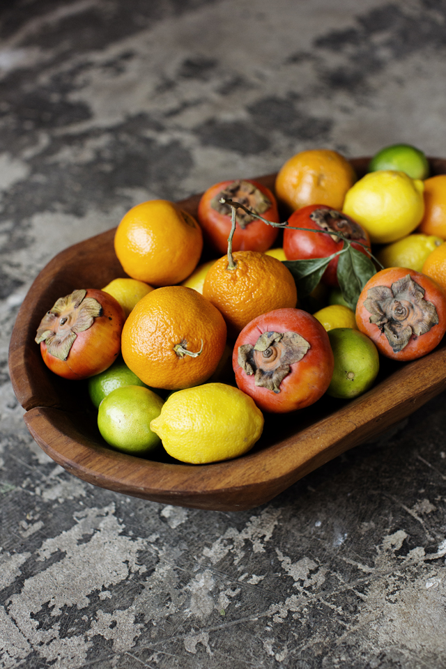 Lemons, limes, persimmons and oranges in a wooden bowl | Young Joni | The Restaurant Project