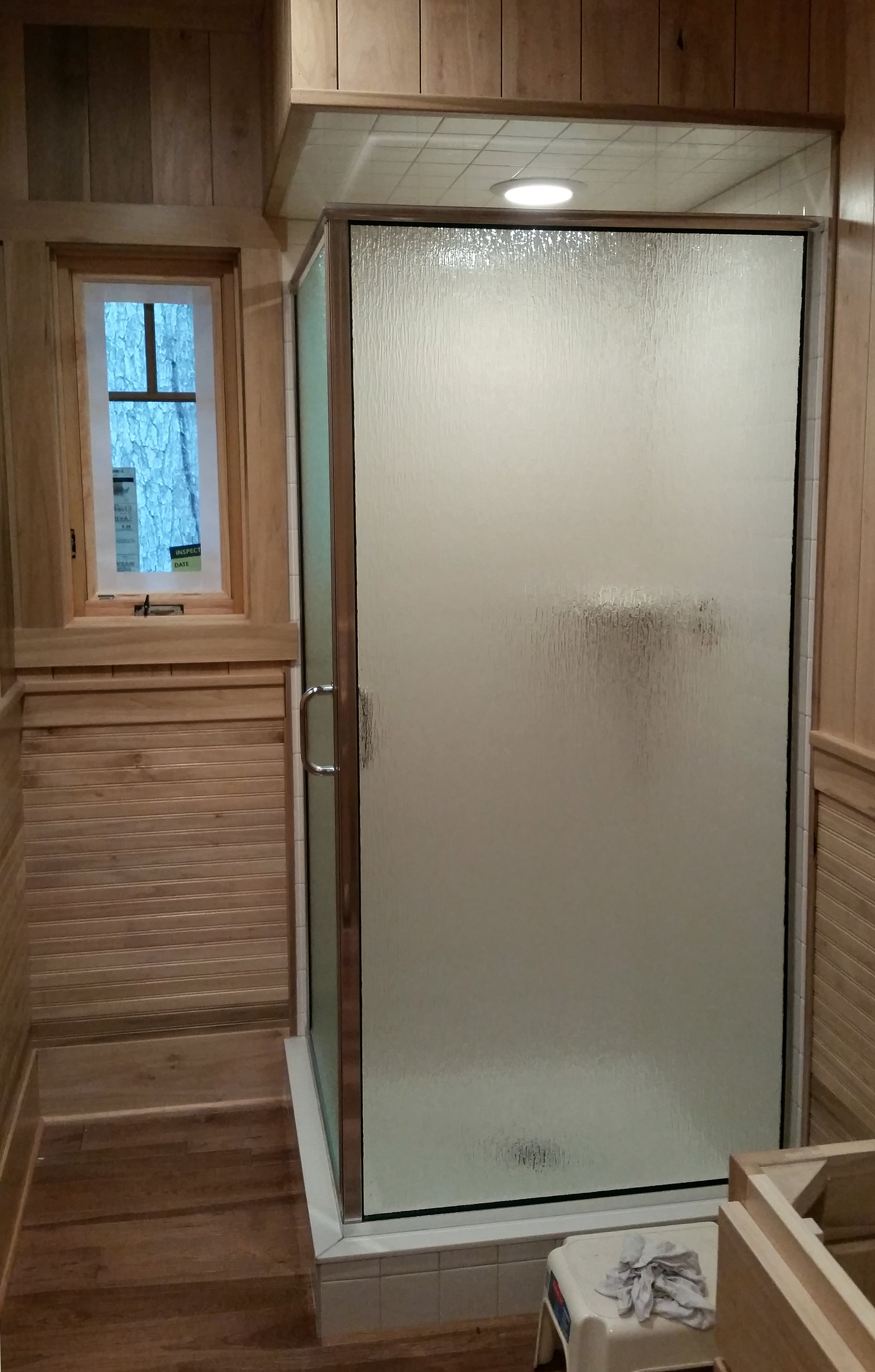 Bathroom corner shower unit with tile surround