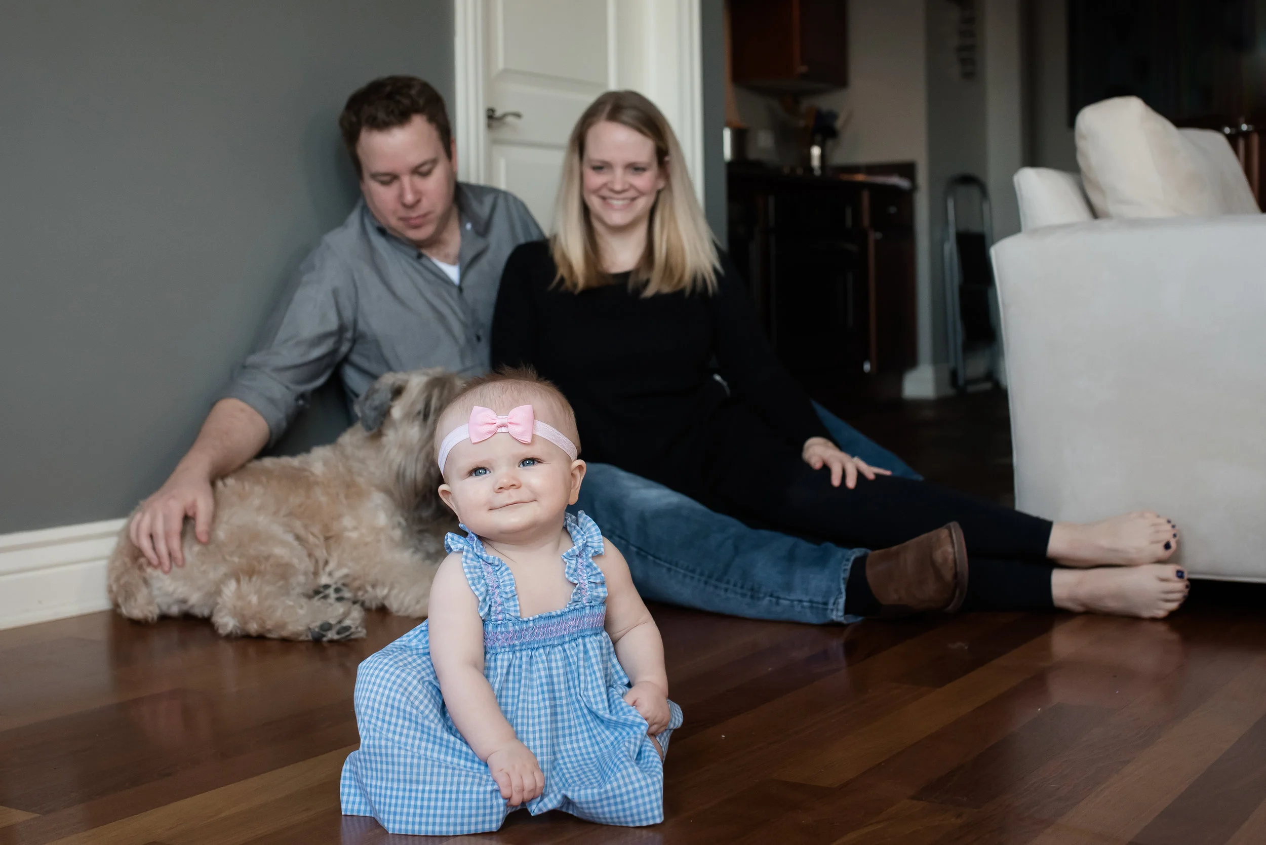 I like this photo for a lot of reasons, but the pup in the back REALLY wanted to play with the babe and it took all of dad's energy to try and get him to sit. Such a cute dog! (And, of course, cute family!)