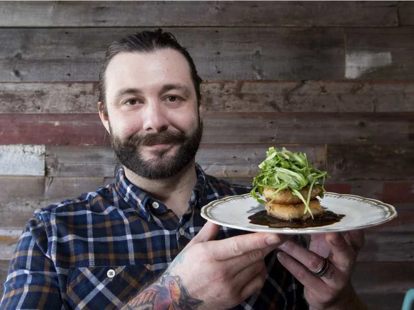 Chartier restaurant owner Darren Cheverie holds a pork jowl cake. GREG SOUTHAM / EDMONTON JOURNAL