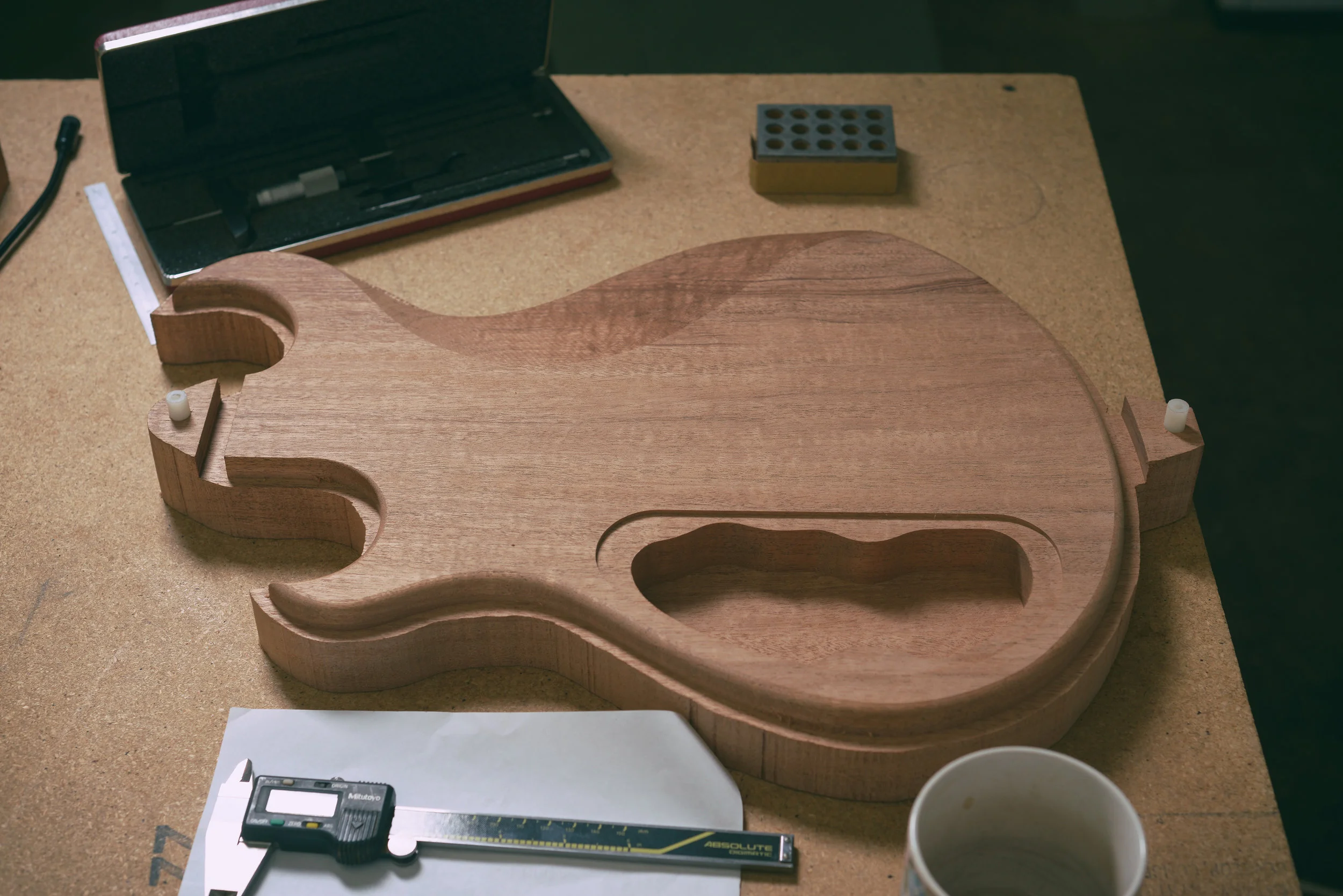 Inspecting body back prior to cutting the body top carve.