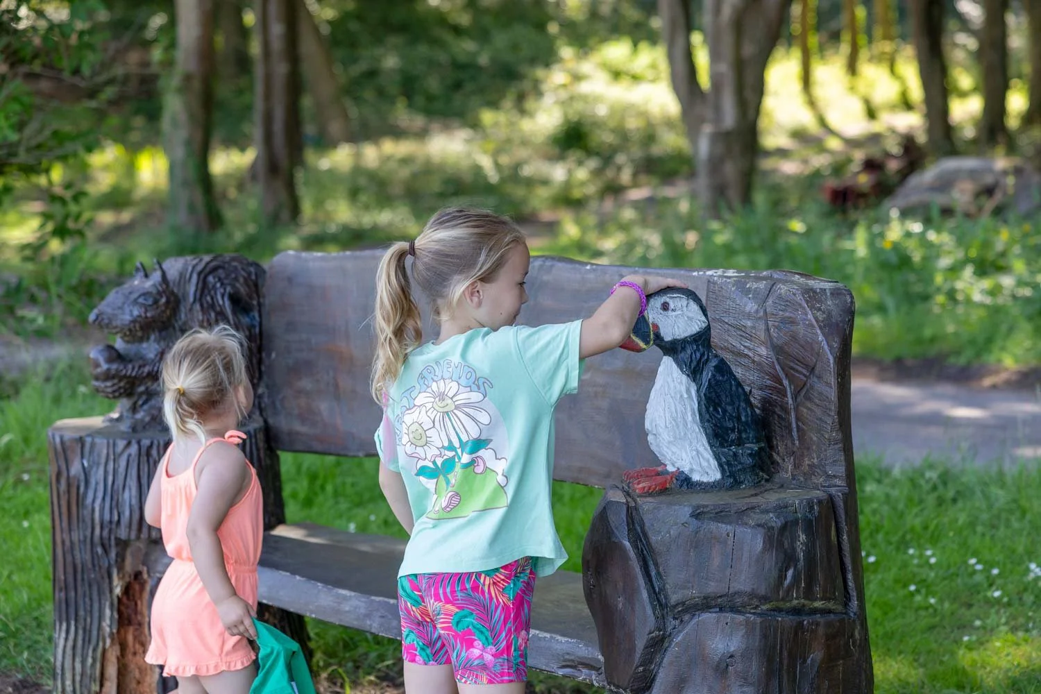 A child plays with a puffin themed bench on caldey island