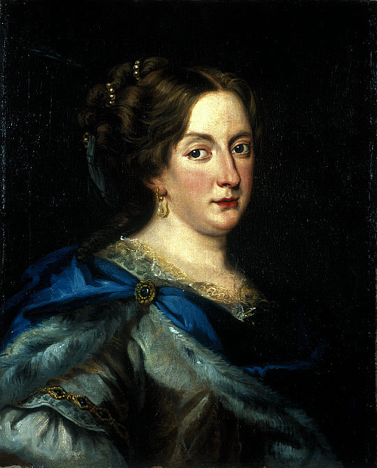 The painting “Christina of Sweden” by Jacob Ferdinand Voet. It features a portrait of Christina, a white woman with brown hair pulled back with gold pieces. She wears a green and blue dress with gold details, gold earrings, and red lipstick. She smiles just slightly and stares at the viewer with dark eyes. Her cheeks and nose are flushed pink.