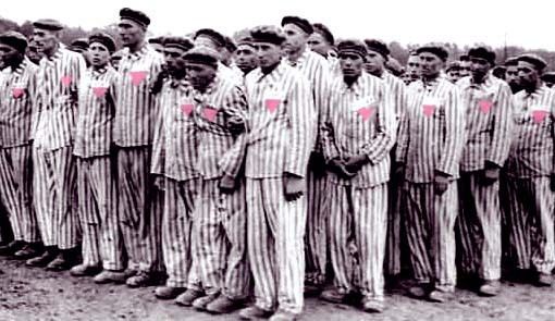 A group of men wearing berets and striped uniforms emblazoned with a pink triangle.