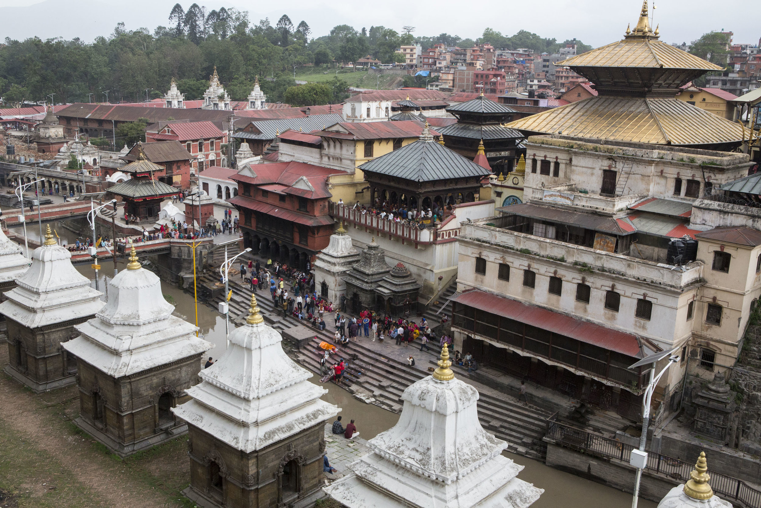  Pashupati complex is built on the banks of the Bagmati River, with its existence dating back to the fifth century. The complex is a place where Hindus and Buddhists come to pray, worship, as well as cremate loved ones. The main temple is home to the