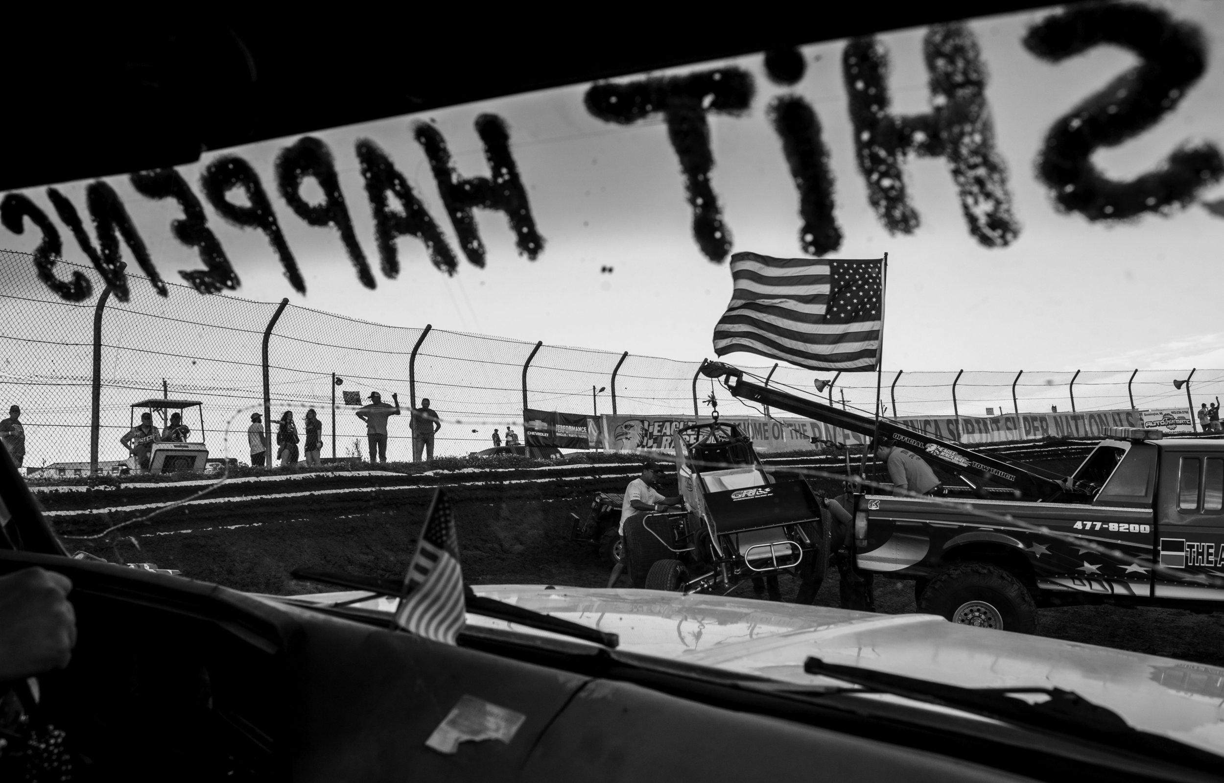  From the view of a push truck crew's window, a trucks tows Clint Benson's spun out car during the hot laps of the World of Outlaws sprint race June 13, 2017 at Eagle Raceway in Eagle, Neb. 