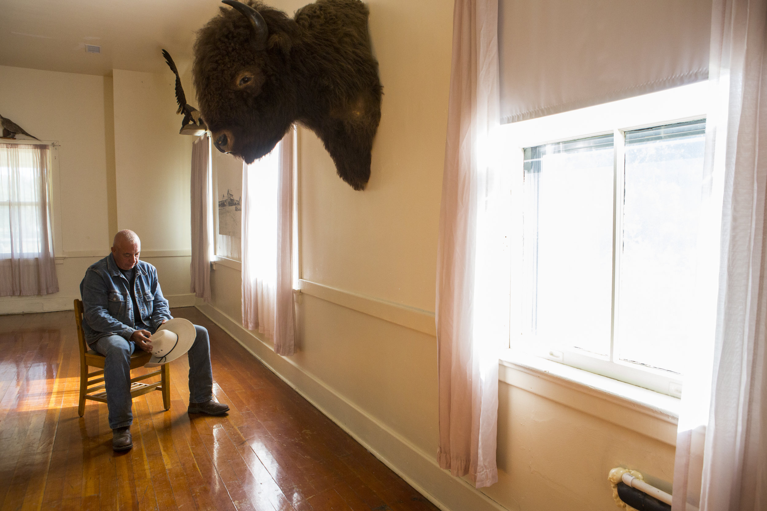  Brewer reflects during a quiet moment in the lodge at Fort Robinson. The lodge was once home to the barracks of soldiers that annihilated his people, however he has no regrets on serving the same military.&nbsp;“The Lakota spirit is a warrior spirit