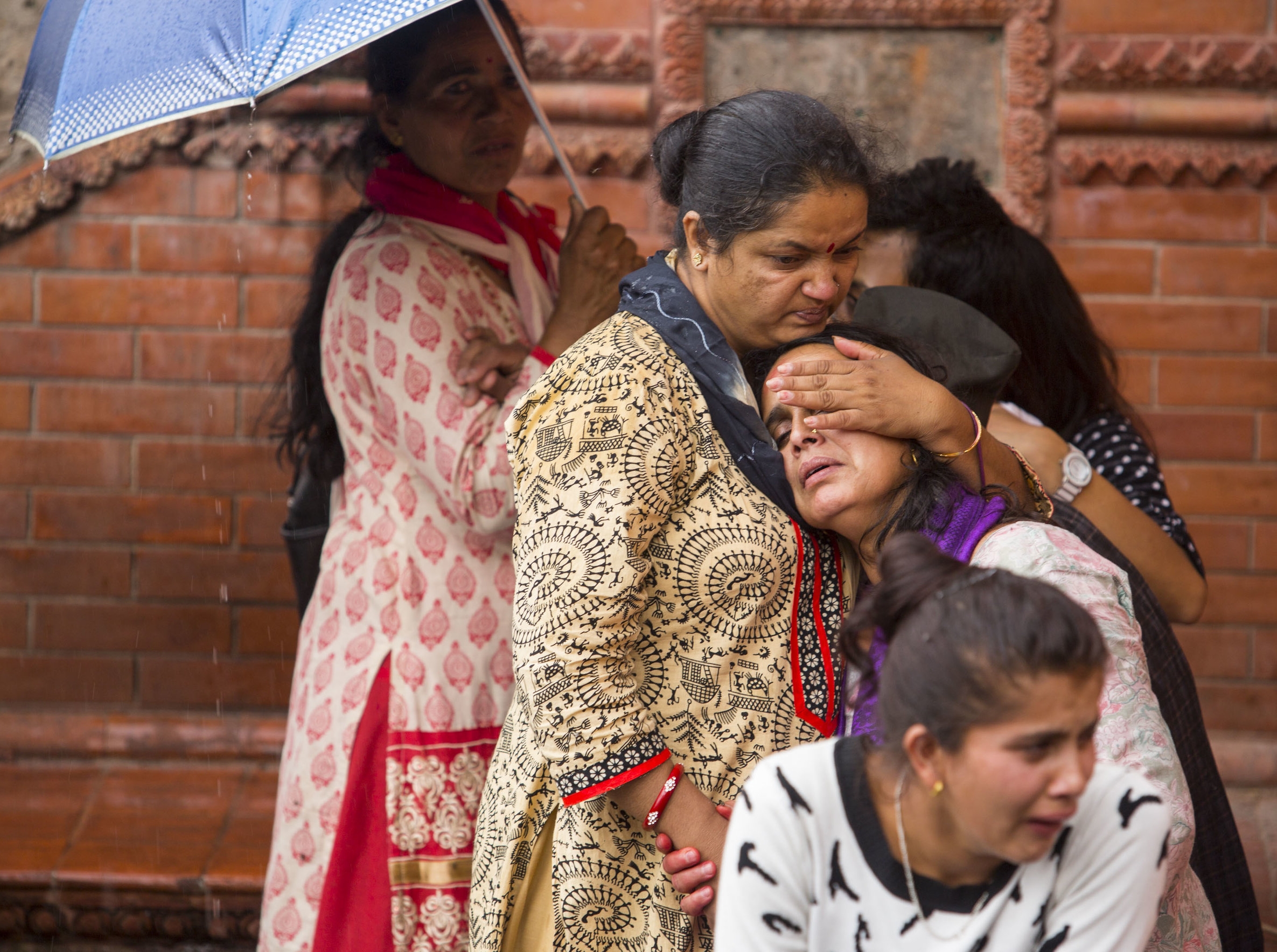  Family members of the deceased grieve during a cremation ceremony on May 18, 2016, at Pashupati in Kathmandu, Nepal. Women are generally supposed to keep back during the four hour cremation. 