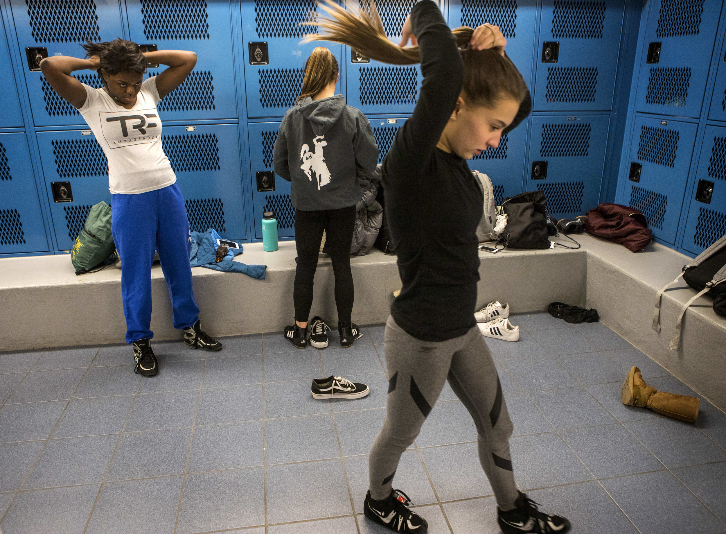  Teammates Annie Batchen, Olivia Roberts and Julia Mahood prepare for practice in the girls’ locker room on Feb. 14, 2018. 