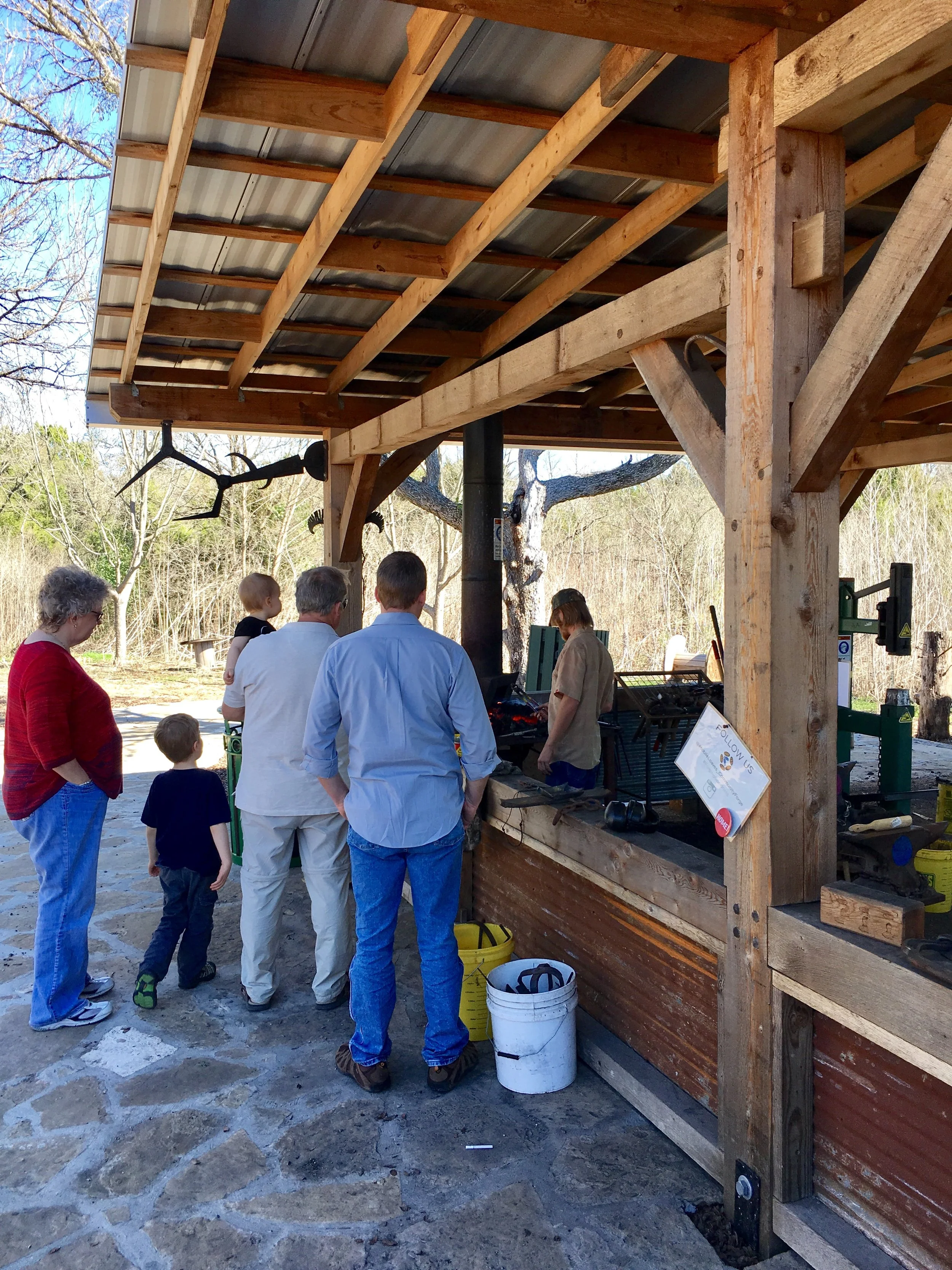 One of our neighbors giving our family a blacksmithing demonstration