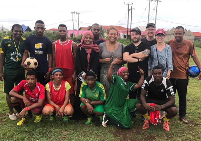  Filming in Zanzibar with our team, Kely (Co-director), Justin Noto (Co-director) and Eric Branco (Director of Photography), pictured with&nbsp;Fatma a local activist and a group of local football players men and women. 