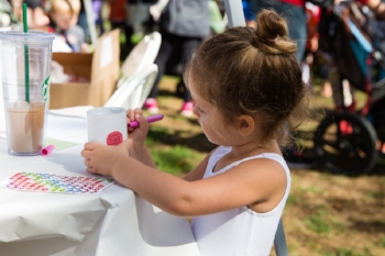 A child decorating her own donation jar at Full Circle