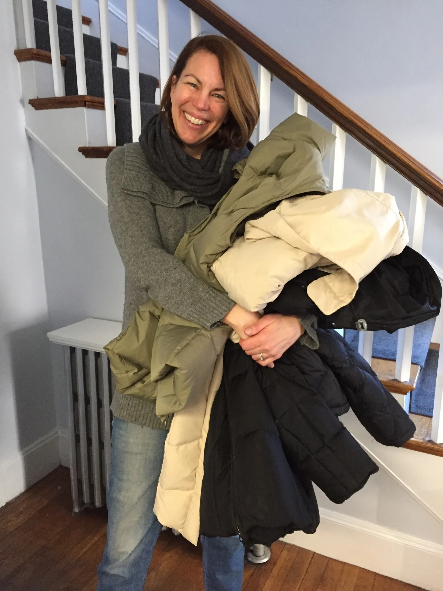 Circle of Hope volunteer holding winter coat donations