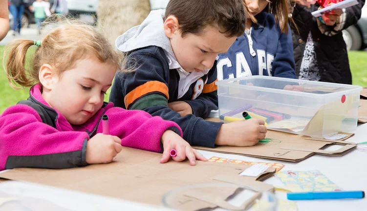 Children decorate donation bags at Circle of Hope event, Full Circle.