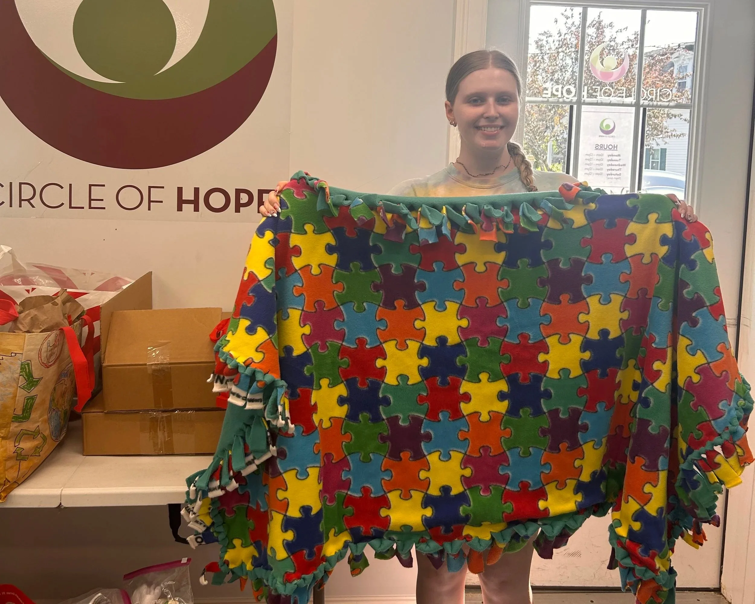   Keira , a senior at Needham High School, donated hand-tied fleece blankets for children in shelters. 