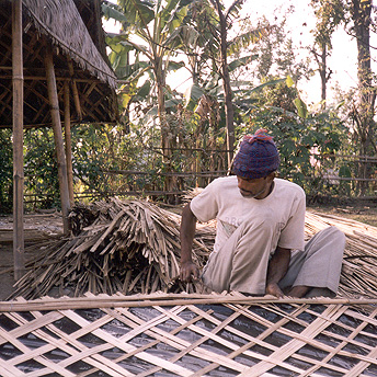   Re-building huts. When we first arrived in Nepal a camp had been made near a river. My family built a hut out of bamboo and plastic. After 15 days we were given rice which meant we could survive. This is the way we have survived for years since. Di