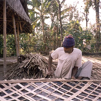 Re-building huts. When we first arrived in Nepal a camp had been made near a river. My family built a hut out of bamboo and plastic. After 15 days we were given rice which meant we could survive. This is the way we have survived for years since. Dil / PhotoVoice / LWF