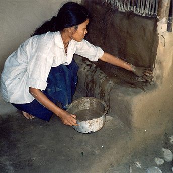  She is smearing her hut with mud.&nbsp; This keeps it clean and tidy which is the only way to eradicate disease.&nbsp; It also makes the hut more decorative. Bishnu Maya  / PhotoVoice / LWF  