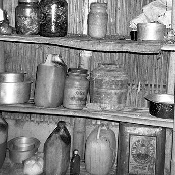 This is where we store pots in our kitchen. In our refugee camp the huts are small and it is too congested. It is difficult to maintain a bedroom and a kitchen. It is just like the shed of a cow. Yethi Raj / PhotoVoice / LWF