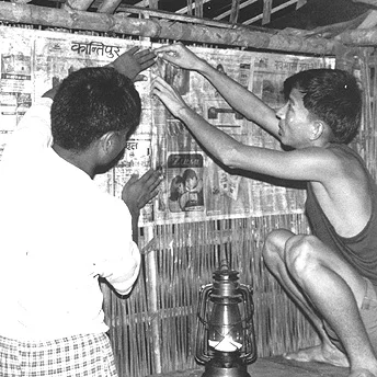 We decorate the inside of the huts with newspaper. This is for extra protection and to stop people seeing through. Mon Maya / PhotoVoice / LWF
