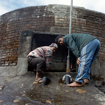   Plumbers maintain the water tank which has been leaking for 2 days    Suresh / PhotoVoice / LWF  