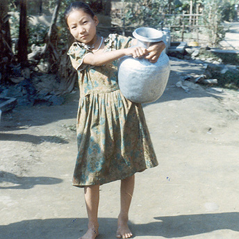 Carrying the water from the tap to the hut. Menuka / PhotoVoice / LWF