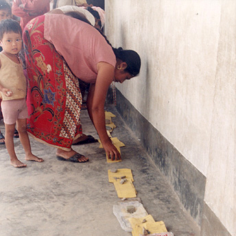  A woman is putting her child’s health care card in line to see the Health Assistant.&nbsp; It takes around two hours of waiting to get a patient check up.&nbsp;&nbsp; The service in the camps is not so good.&nbsp;&nbsp; Ram  / PhotoVoice / LWF  