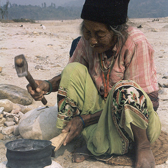  A old woman is breaking stones with a hammer. The food items given in rations are not nutritious enough and we are not given clothes.&nbsp; People do this work in order to earn money to buy extra vegetables and some clothes. Tila Maya / PhotoVoice /