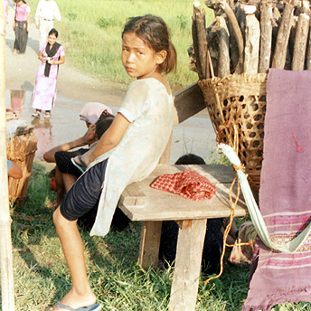   A girl rests from carrying firewood,    Prem / PhotoVoice / LWF  