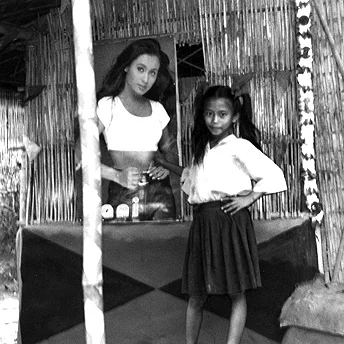 Girl outside hut. Nar Bdr / PhotoVoice / LWF