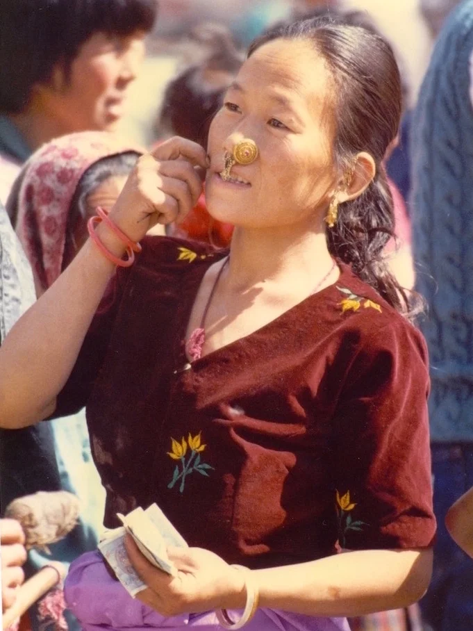 A Southern Bhutanese woman selling her produce in Thimphu market in the mid-1980s. From 1989, Southern Bhutanese were required to wear Northern Bhutanese traditional dress in public. Catriona Heale