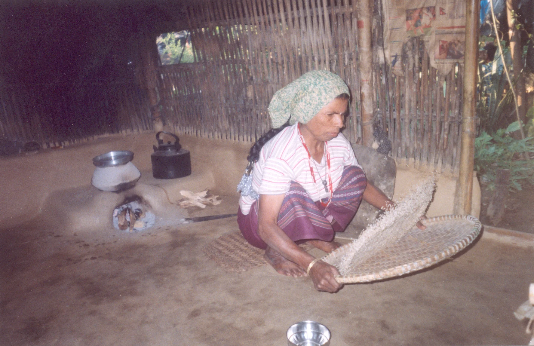 Winnowing and cleaning the rice. Bhimma / PhotoVoice / LWF