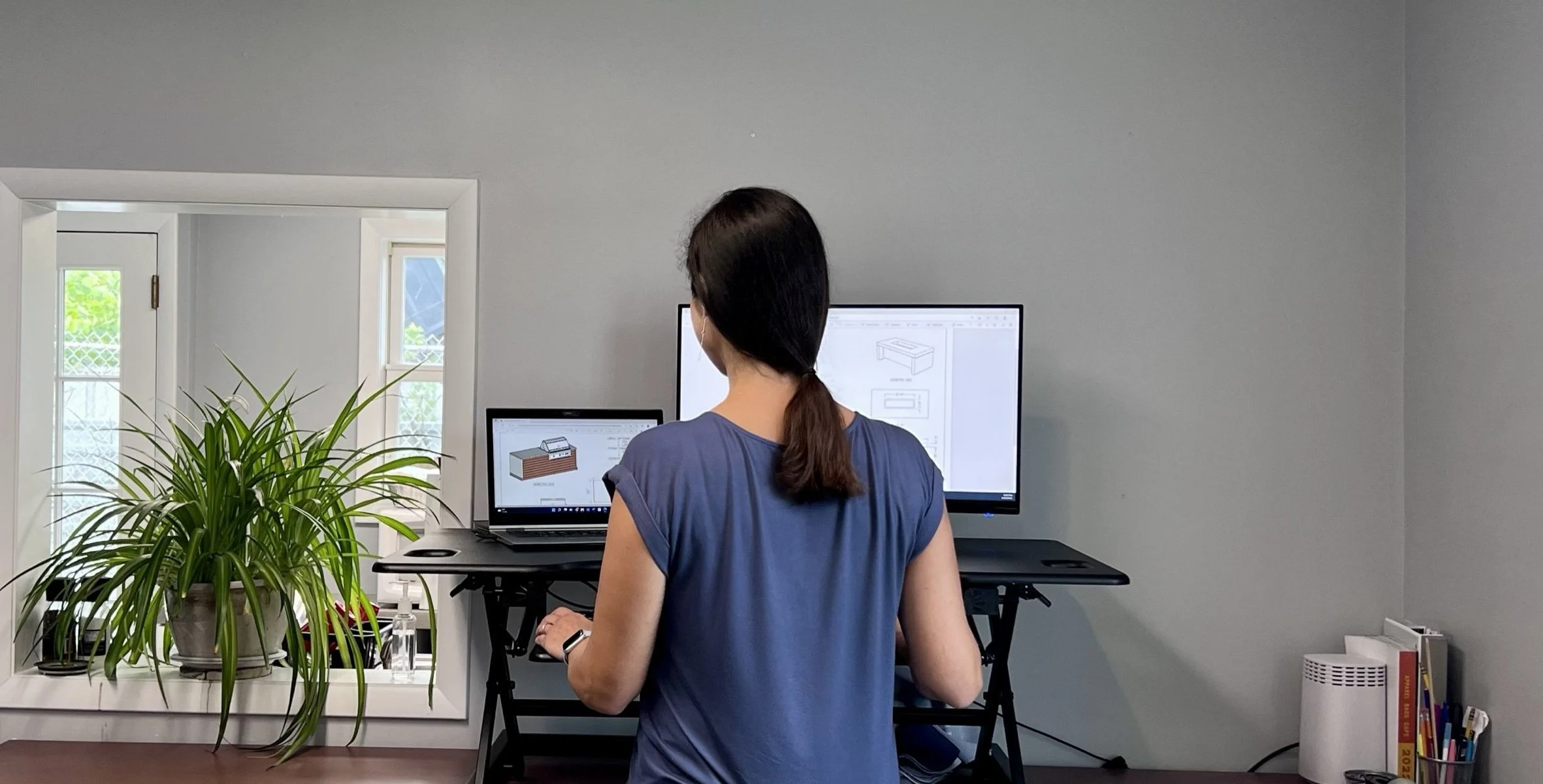 designer in front of Hyde Concrete drawings.jpeg