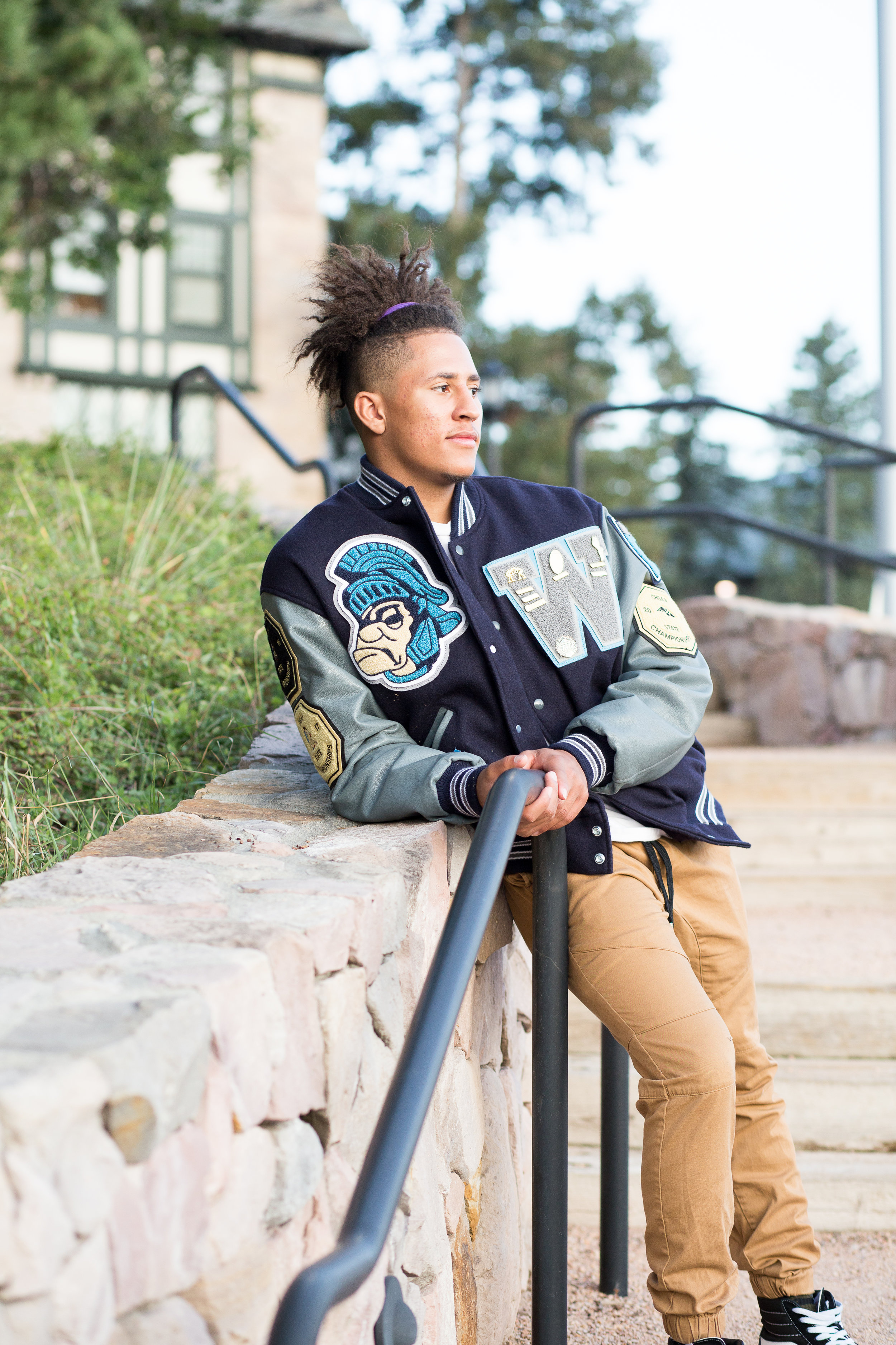 Colorado Springs high school senior leaning against a stone wall on the Colorado College campus looking into the sun Stacy Carosa Photography Colorado Springs senior photography