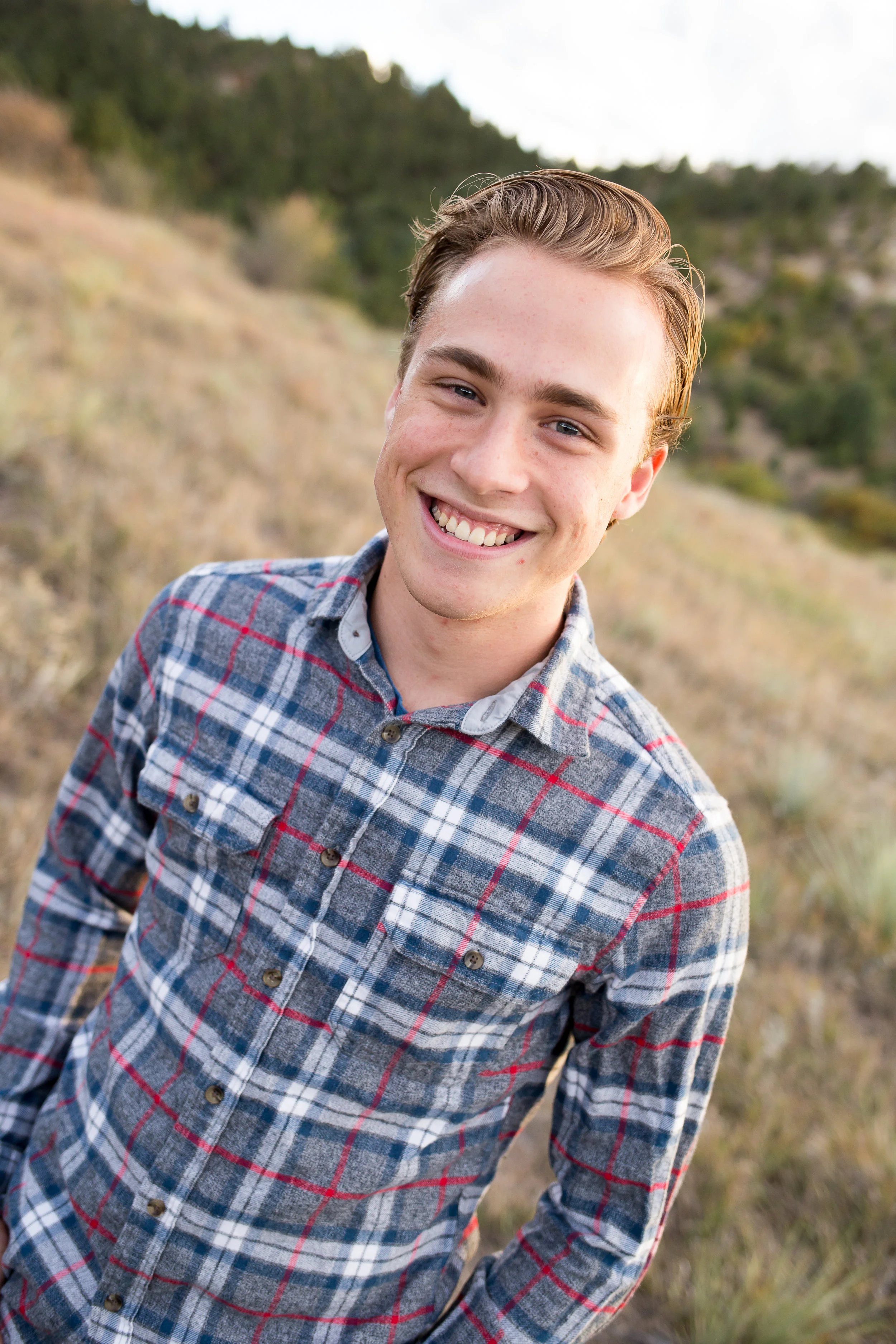 Senior boy standing in field | Colorado Springs Senior Photography | Colorado Springs Senior Photographer | Stacy Carosa Photography | Colorado Senior Portraits | Doherty High School
