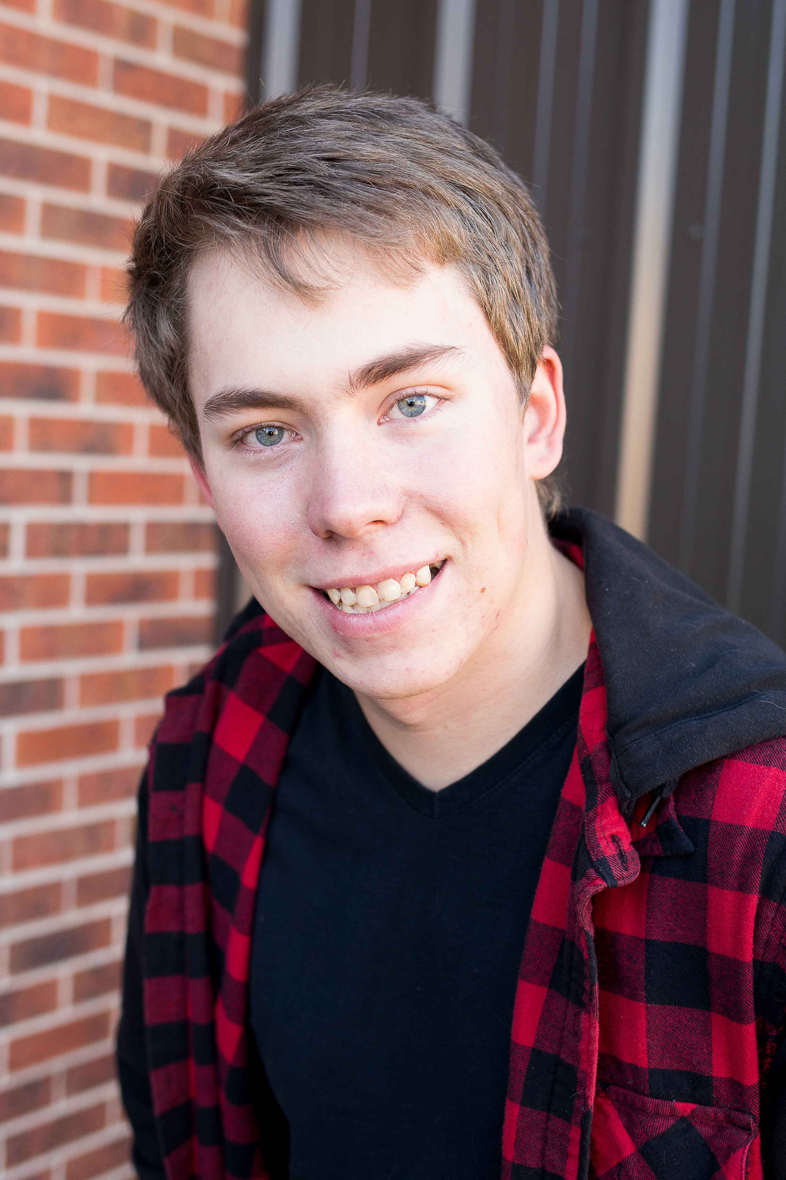 Stacy Carosa Photography | Colorado Springs Senior Photographer | senior boy standing near brick building for senior session photos in the fall