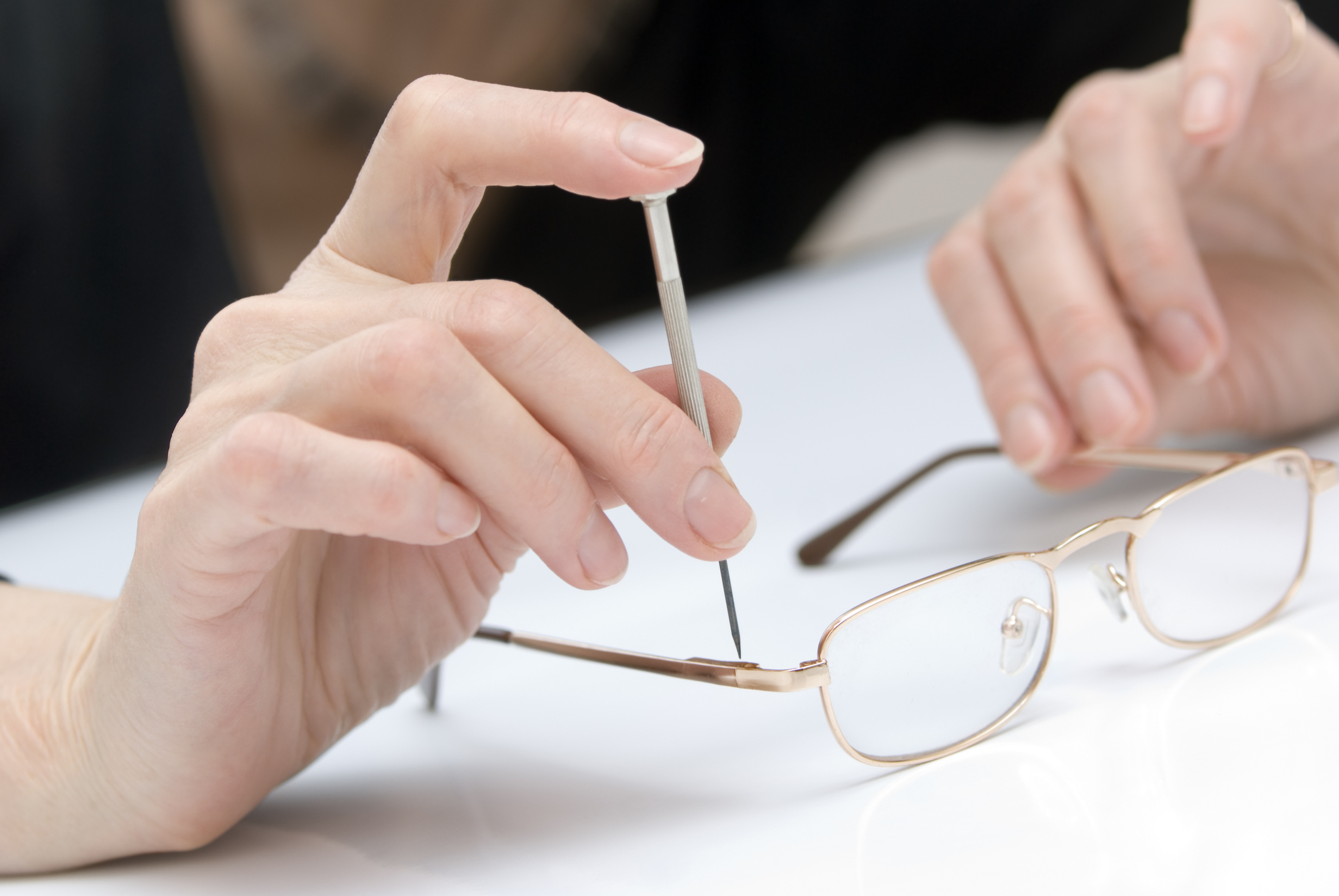 Adjusting and repairing eyeglasses frames.