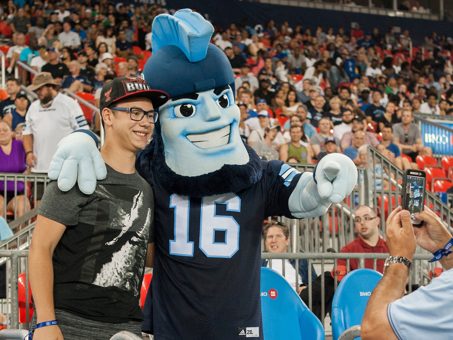 argonauts mascot posing with fan