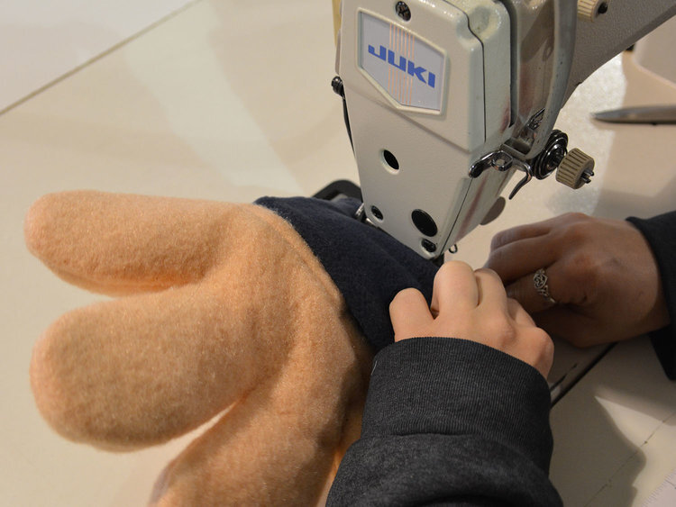 mascot designer sewing hand