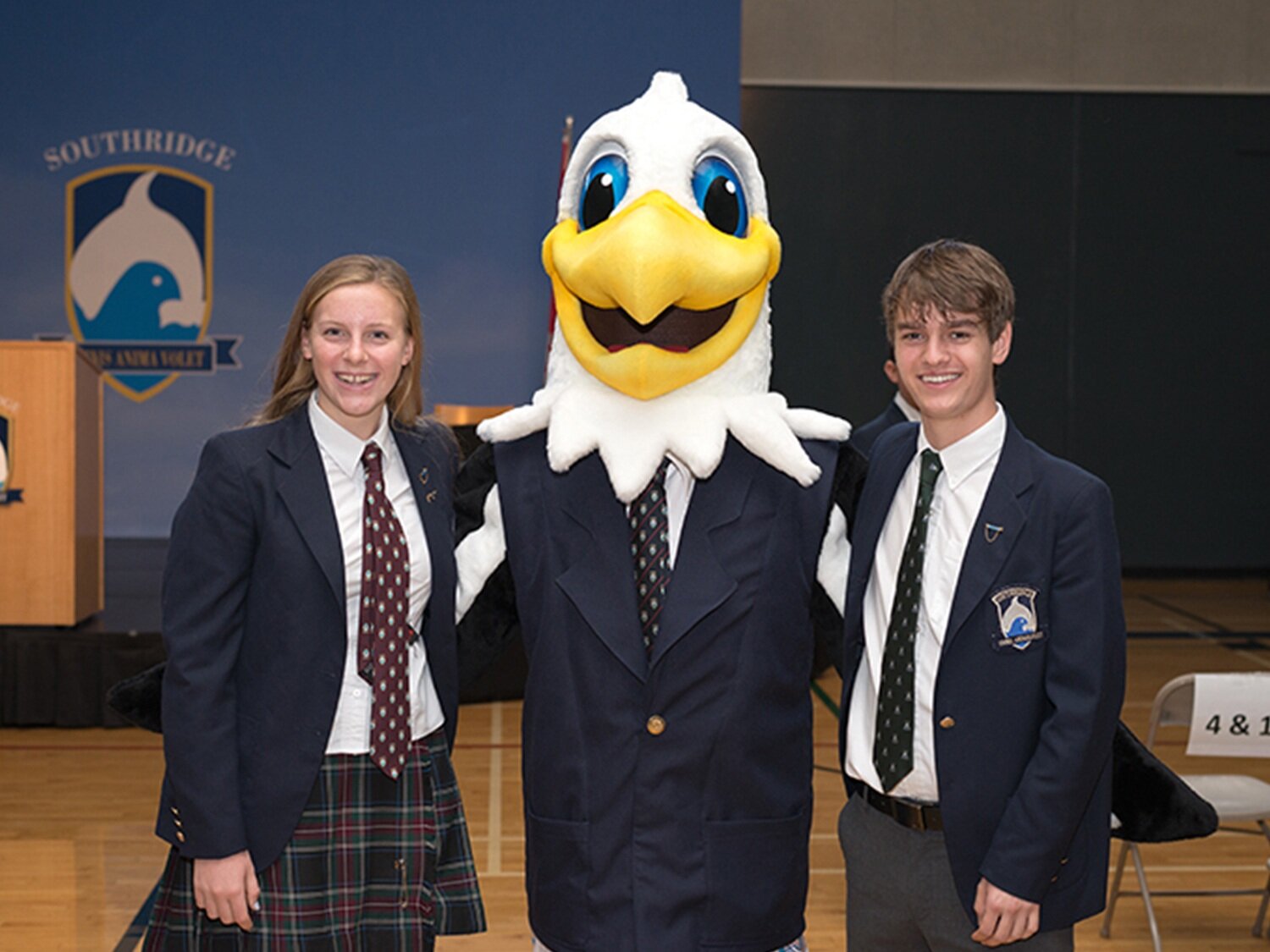 sal eagle orca mascot with students