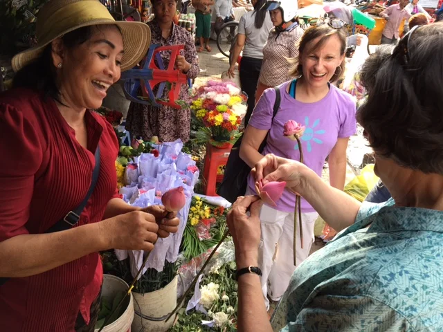 Kay learns the art of folding a Cambodian Lotus Flower, from the market where we buy fresh flowers and produce every weekend. 