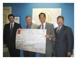 Jack Toan from Wells Fargo Bank presents a check for $100,000 for the technical assistant program 2008 - 2009 to the partnership between Small Business Financial Development Corporation of Orange County and Hispanic Business Consultants.(From right …
