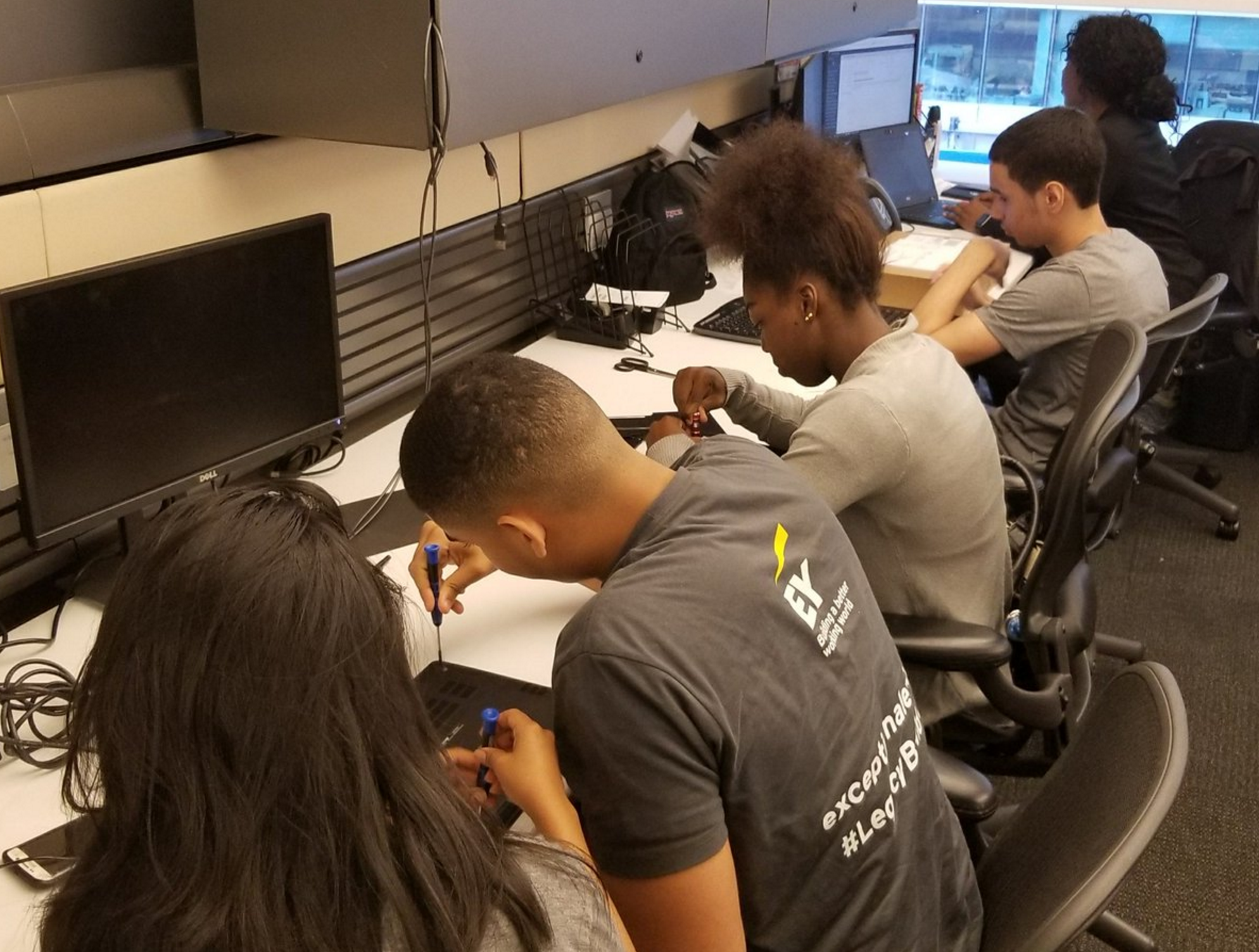High school interns developing skills in hardware and databases at EY.