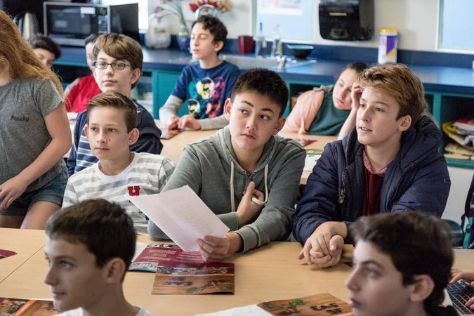 Students at the Brandeis School of San Francisco listening to Ms. Bonini on Wednesday. Charities pitch to the students to request a share of their funding. Credit Jason Henry for The New York Times