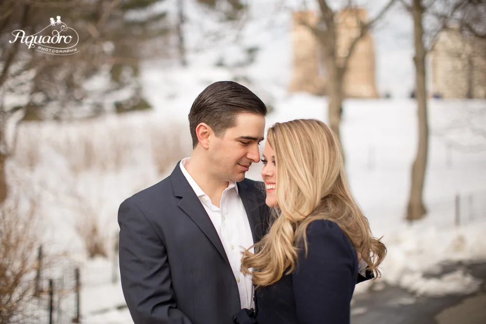engaged couple in snowy Central Park