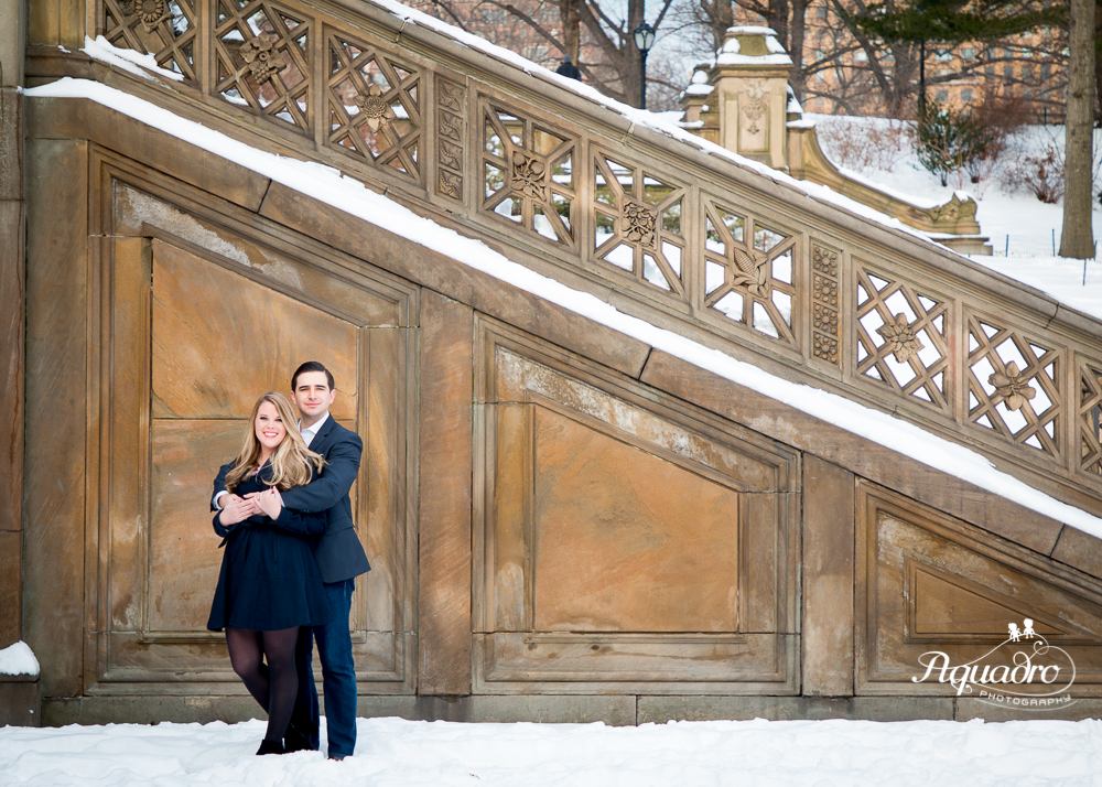 Engaged Couple by snowy Bethesda Terrace stairs