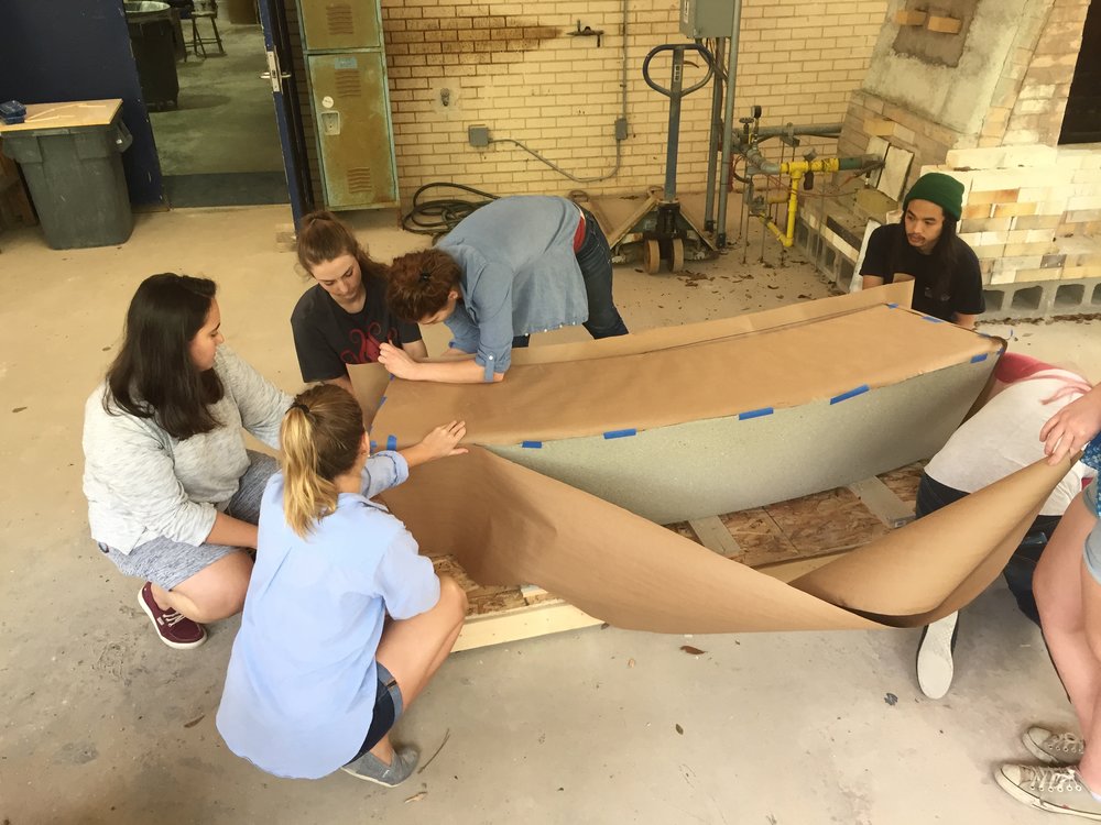  Students using butcher paper to create a template of the concrete bench.   
