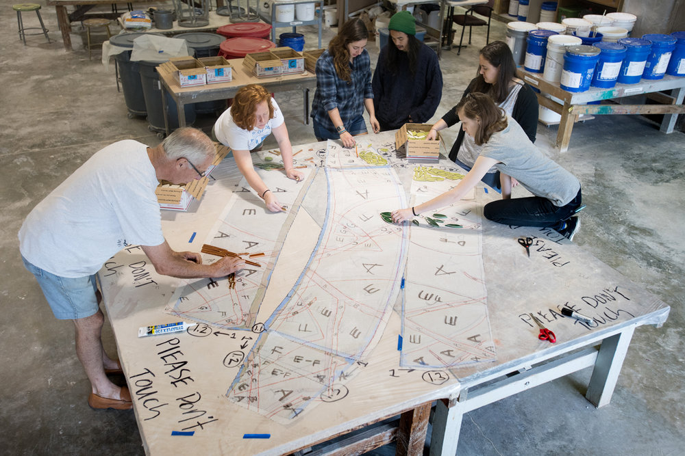  Students working on the transfer of the mosaic design to the mesh blanket.   