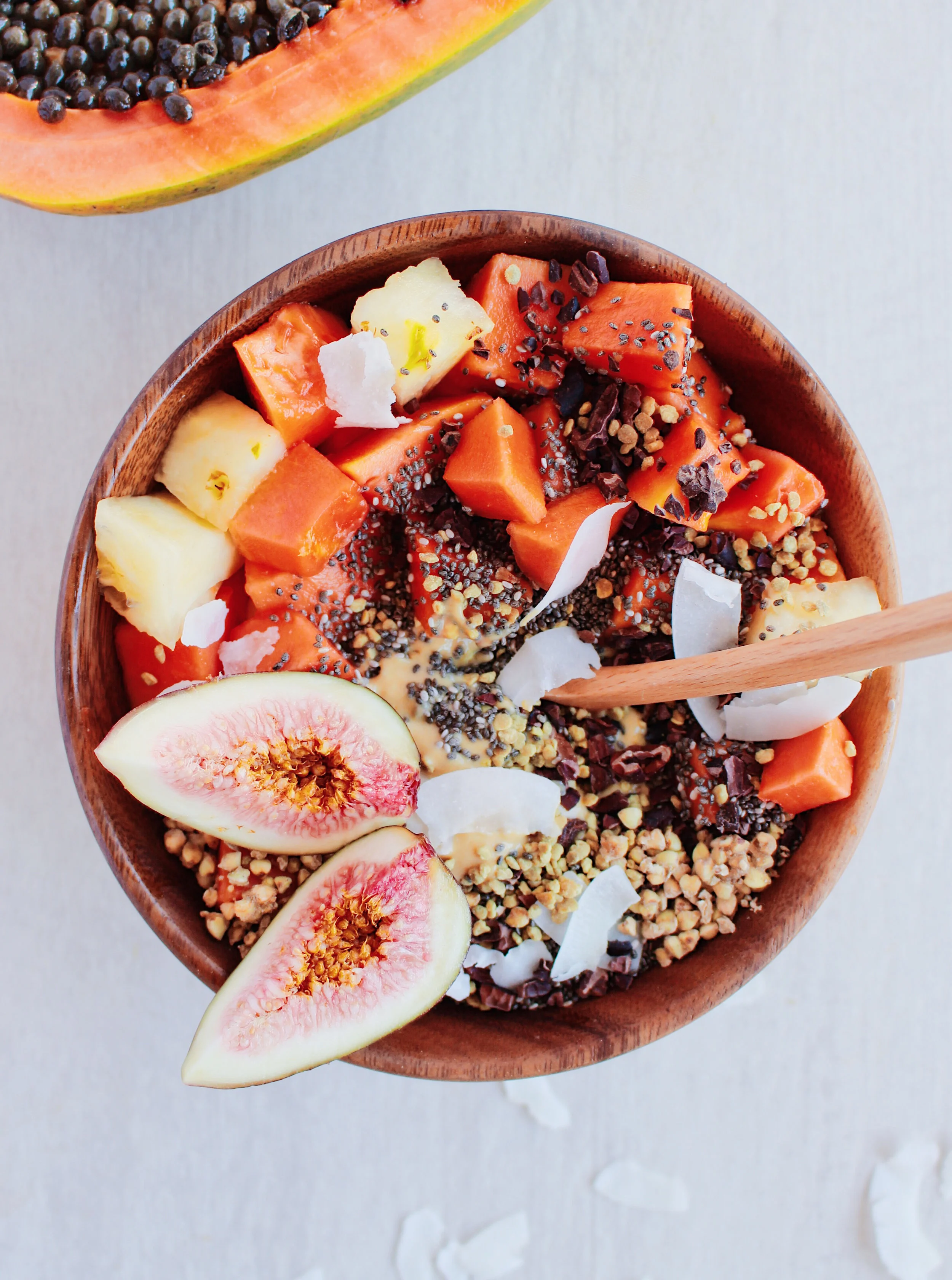 My tropical smoothie bowl topped with buckinis, papaya, cacao nibs & chia seedss